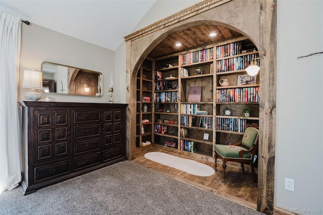 living area with lofted ceiling and carpet flooring