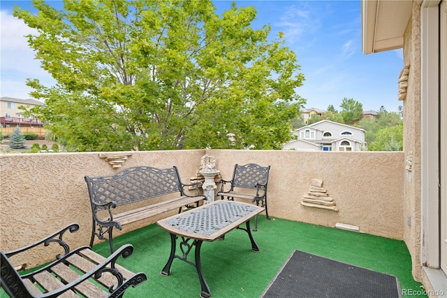 view of patio featuring a balcony