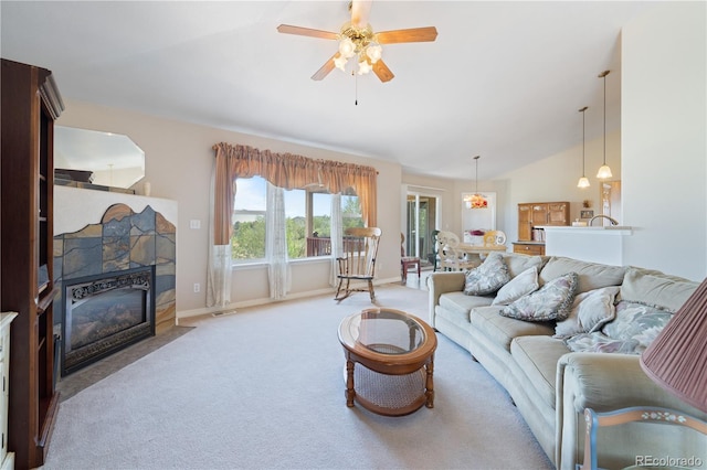 carpeted living room featuring a fireplace with flush hearth, baseboards, a ceiling fan, and vaulted ceiling