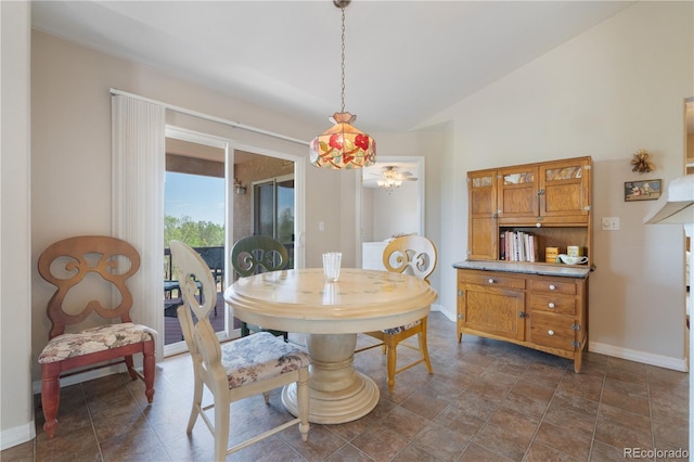 dining area with baseboards and lofted ceiling