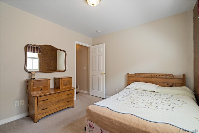 bedroom featuring baseboards and light colored carpet