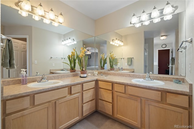 full bath with a sink and double vanity