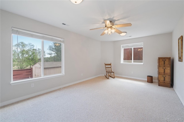 interior space featuring visible vents, plenty of natural light, baseboards, and ceiling fan