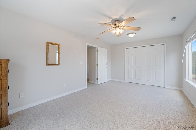 unfurnished bedroom with visible vents, light carpet, and baseboards