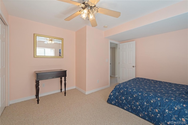 carpeted bedroom with ceiling fan and baseboards