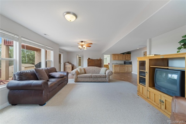 carpeted living area with baseboards and visible vents