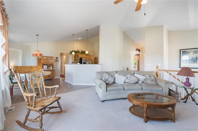 living area featuring lofted ceiling, carpet floors, and ceiling fan