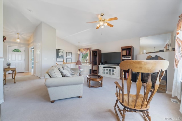 living room with lofted ceiling, carpet flooring, a ceiling fan, and visible vents