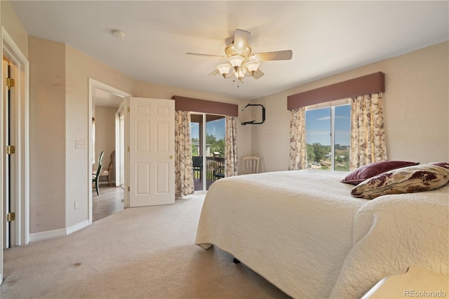 carpeted bedroom featuring access to exterior, a ceiling fan, and baseboards