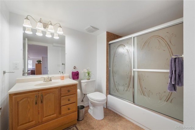 bathroom featuring visible vents, bath / shower combo with glass door, toilet, tile patterned floors, and vanity