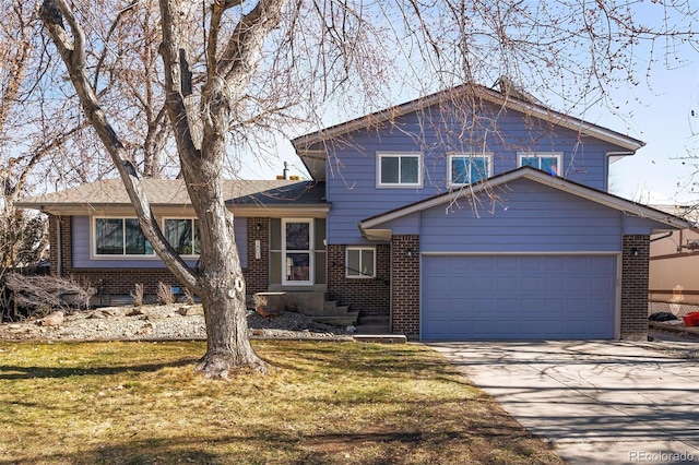 split level home featuring a garage, brick siding, driveway, and a front lawn