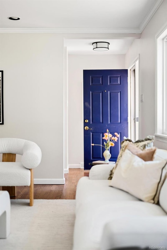 bedroom featuring crown molding, baseboards, and wood finished floors