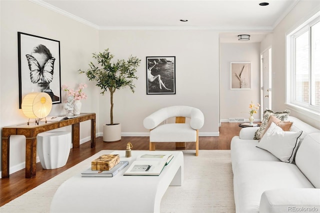 living area with ornamental molding, visible vents, baseboards, and wood finished floors