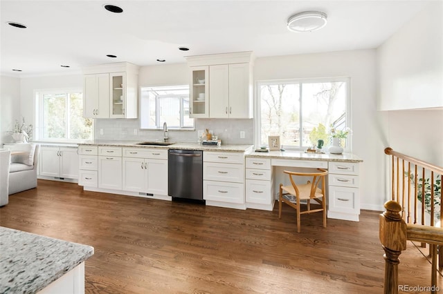 kitchen with dishwasher, a sink, dark wood finished floors, and decorative backsplash