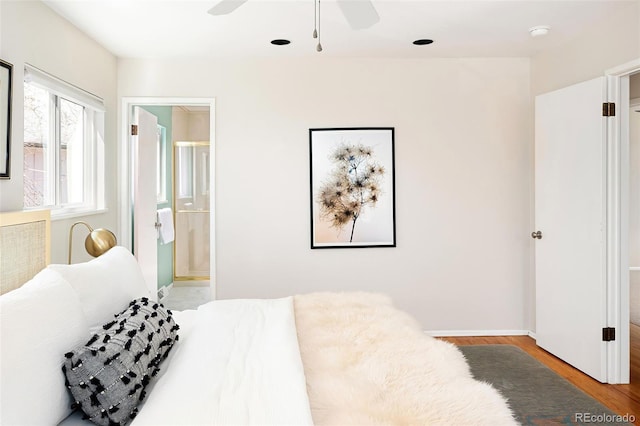 bedroom featuring connected bathroom, a ceiling fan, and light wood-style floors