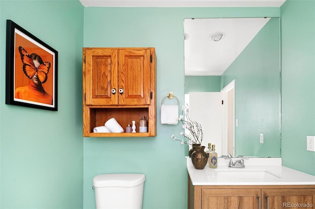 half bathroom with toilet and vanity