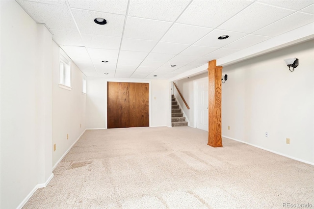 carpeted empty room with recessed lighting, stairway, a drop ceiling, and baseboards