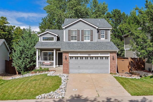 view of property featuring a porch, a garage, and a front yard