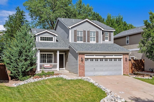 view of property with a garage, covered porch, and a front yard