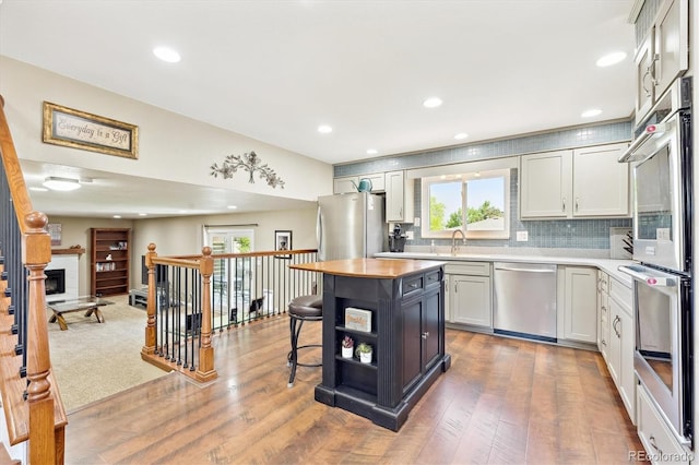 13266 Canopus Dr, Lone Tree, CO 80124 - kitchen with stainless steel appliances, plenty of natural light, wood finished floors, and recessed lighting