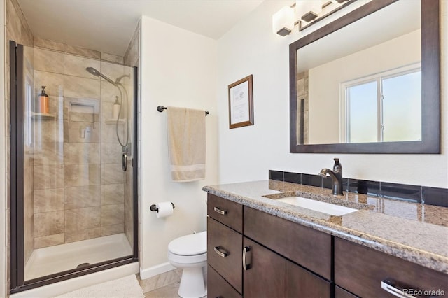 13266 Canopus Dr, Lone Tree, CO 80124 - bathroom with toilet, vanity, a stall shower, baseboards, and tile patterned floors