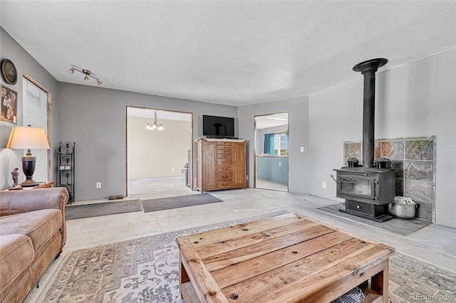 21494 Way Of Peace, Deer Trail, CO 80105 - living area with a wood stove and a textured ceiling
