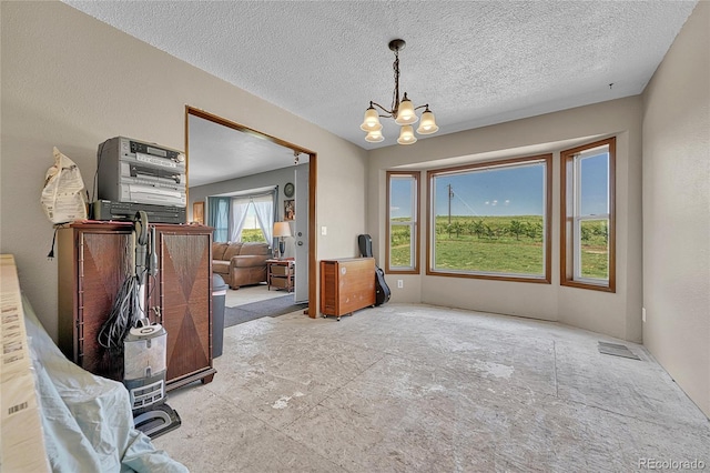 21494 Way Of Peace, Deer Trail, CO 80105 - dining room with a chandelier and a textured ceiling