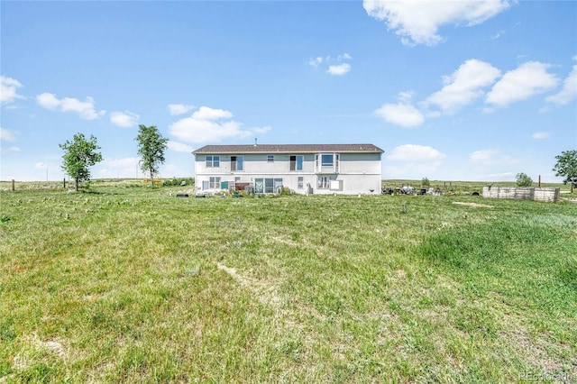 21494 Way Of Peace, Deer Trail, CO 80105 - rear view of house featuring a rural view, stucco siding, and a yard