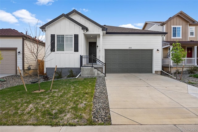 view of front of home with a front lawn, board and batten siding, an attached garage, and driveway