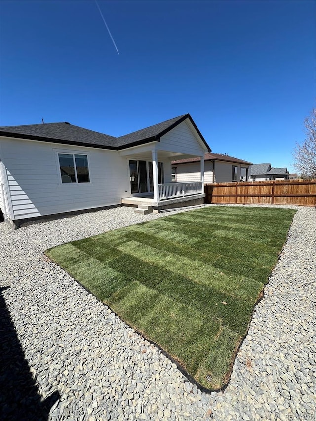rear view of house with a patio area, fence, and a lawn