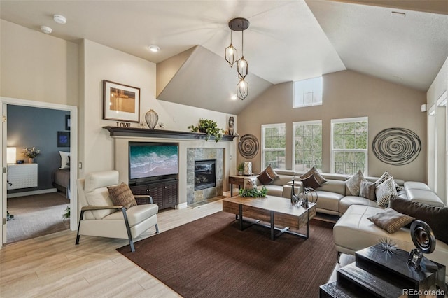 7548 S Biloxi Way, Aurora, CO 80016 - living area featuring wood finished floors, a tile fireplace, and lofted ceiling
