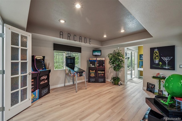 7548 S Biloxi Way, Aurora, CO 80016 - home office featuring wood finished floors, recessed lighting, plenty of natural light, a raised ceiling, and a textured ceiling