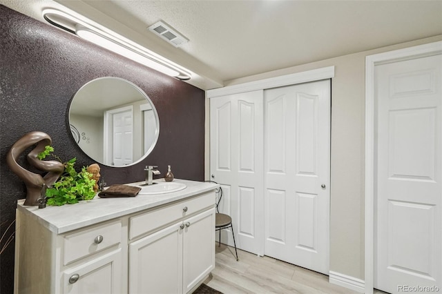 7548 S Biloxi Way, Aurora, CO 80016 - bathroom featuring vanity and wood finished floors