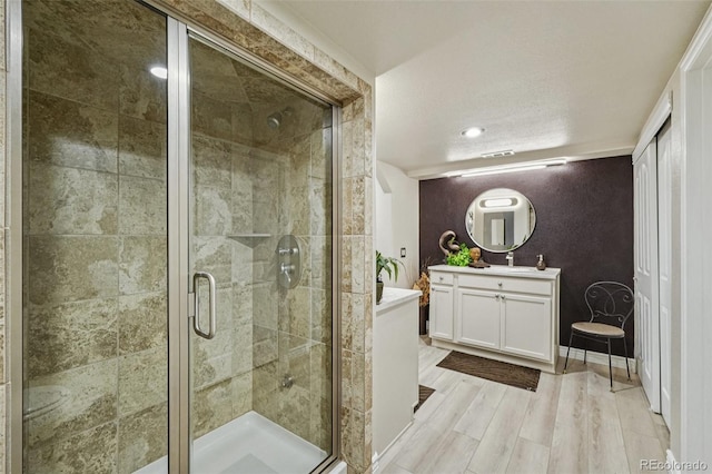 7548 S Biloxi Way, Aurora, CO 80016 - full bathroom featuring vanity, a stall shower, and wood finished floors