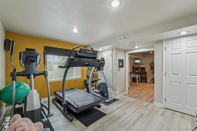 7548 S Biloxi Way, Aurora, CO 80016 - exercise room with light wood finished floors, a textured ceiling, and recessed lighting