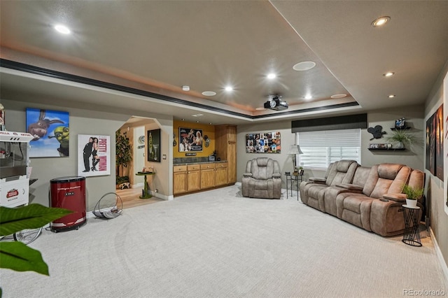 7548 S Biloxi Way, Aurora, CO 80016 - home theater featuring recessed lighting, a tray ceiling, light colored carpet, and arched walkways