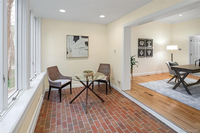 living area with brick patterned floors, baseboards, and recessed lighting