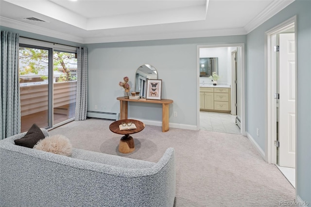 sitting room with baseboard heating, light colored carpet, a tray ceiling, ornamental molding, and baseboards