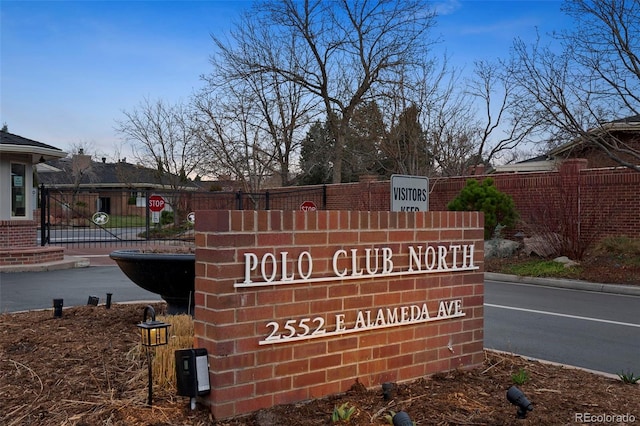 community / neighborhood sign with fence