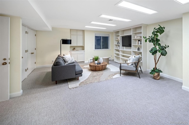 living area with light carpet, baseboards, and baseboard heating