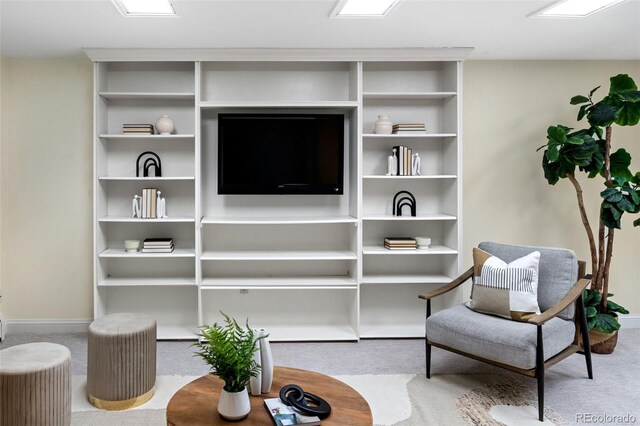 living area with carpet flooring and baseboards