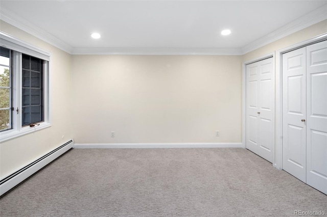 unfurnished bedroom featuring baseboard heating, crown molding, carpet, multiple closets, and recessed lighting