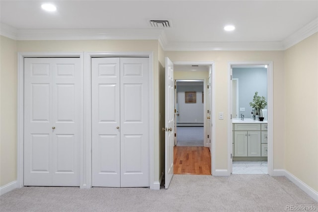 unfurnished bedroom with carpet floors, baseboard heating, ornamental molding, baseboards, and recessed lighting