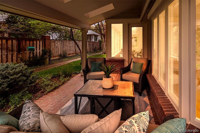 sunroom with an outdoor hangout area and a skylight