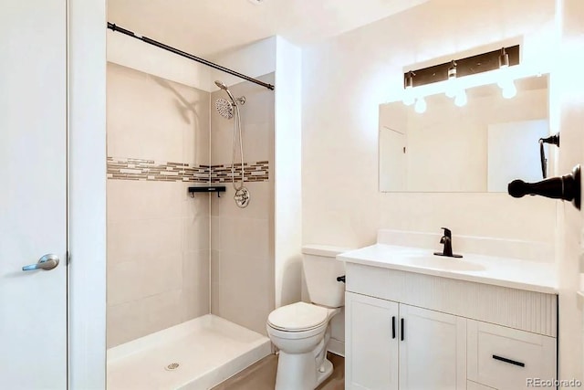 full bath featuring vanity, toilet, and a shower stall