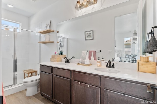 22826 E Tufts Pl Unit A, Aurora, CO 80015 - full bathroom featuring double vanity, a stall shower, plenty of natural light, and wood finished floors