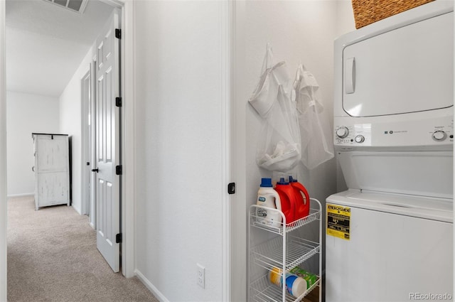 22826 E Tufts Pl Unit A, Aurora, CO 80015 - laundry room with stacked washer / dryer and carpet