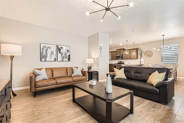 764 N Quatar St, Aurora, CO 80018 - living room featuring a chandelier and light wood-style flooring