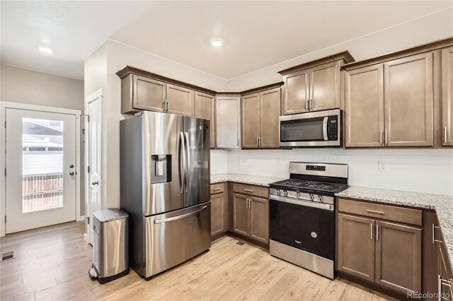 764 N Quatar St, Aurora, CO 80018 - kitchen featuring appliances with stainless steel finishes, light wood-style floors, tasteful backsplash, light stone countertops, and recessed lighting