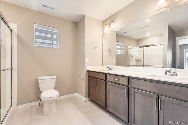 764 N Quatar St, Aurora, CO 80018 - full bath with a shower stall, double vanity, healthy amount of natural light, and tile patterned floors